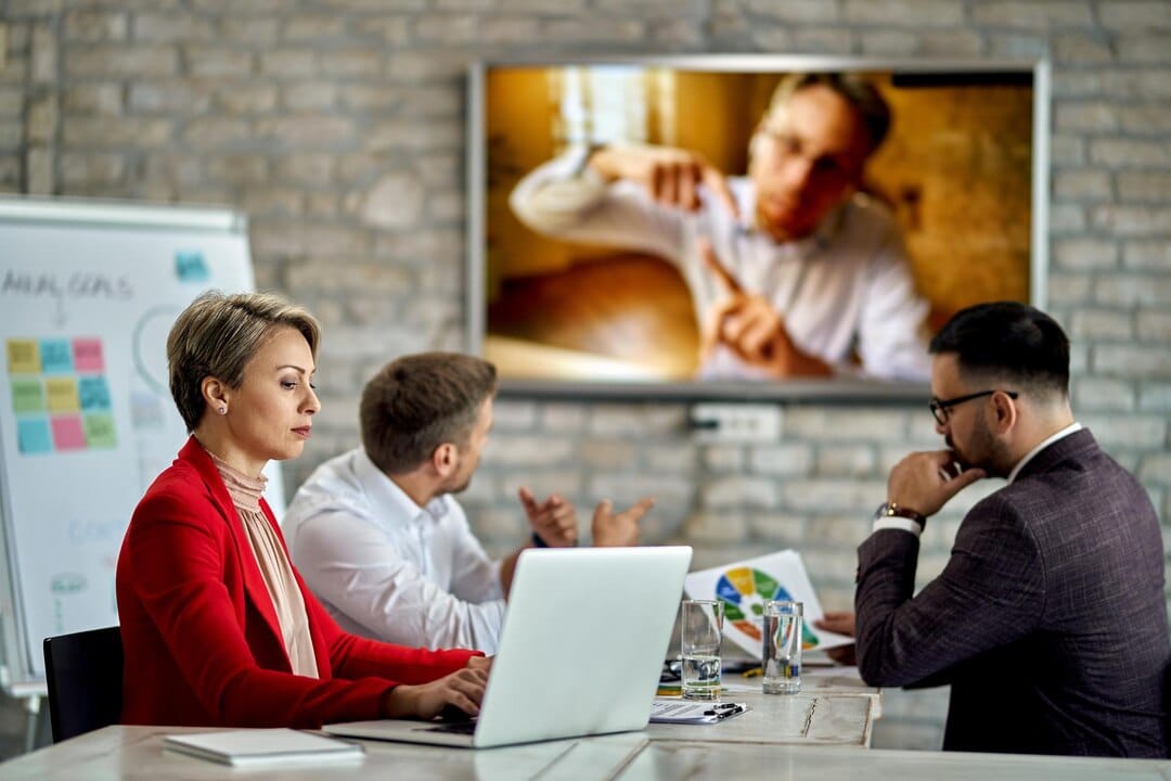 businesswoman working computer while having meeting office one her colleagues is joining meeting via video call 637285 6961